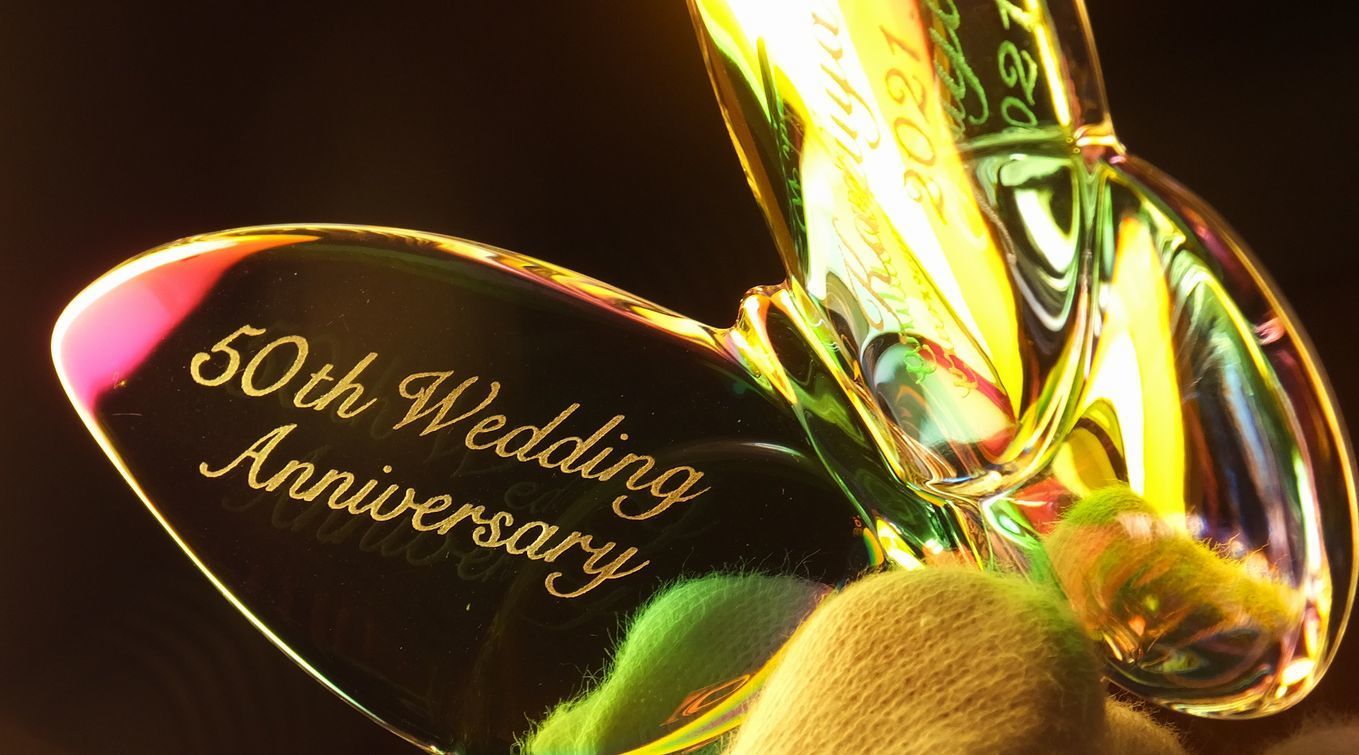 バカラのラッキーバタフライイリゼクリアに、結婚50周年を祝う名入れ彫刻。お二人の名前と記念日が羽根のデザインに美しく刻まれ、永遠の愛を象徴する特別なアニバーサリーギフト