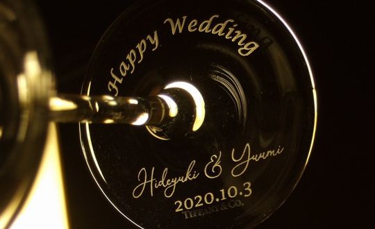 ティファニーワイングラスの底面に「Happy Wedding」の文字とお二人の名前、記念日を芸術的に彫刻した特別な結婚祝い。2つの異なる書体を駆使したデザインが、より一層美しく華やかな印象を与えます