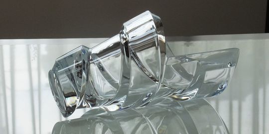 バカラのファウナクリストポリスの一輪挿しがテーブルの上に置いてある写真。動物のモチーフが繊細に施された、ユニークで芸術的な一輪挿しが、光を反射して輝き、名入れギフトとしての個性と、空間に物語を添える洗練された美しさを演出しています。