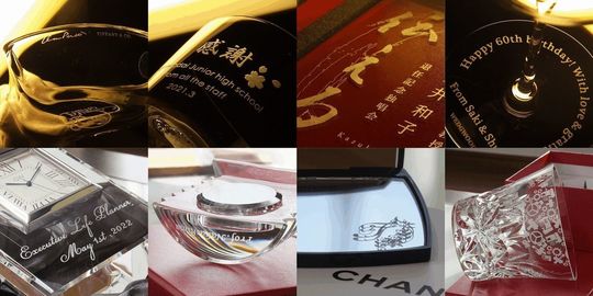 グラスワークス ナルミの置き時計『アーチ クロック』に、『CBGM』というロゴデザインと『Thank you for contribution!』、そして日付を名入れ彫刻した写真。透明なクリスタルの時計に、貢献を称える感謝のメッセージと企業のロゴが丁寧に刻まれています。企業向けの記念品や表彰品に最適な贈り物です。