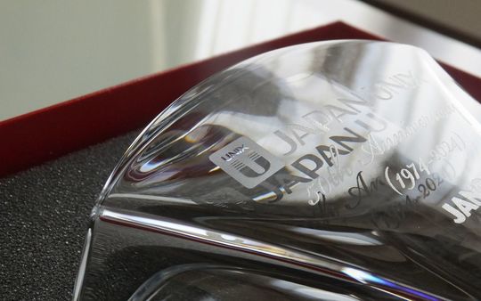 法人ギフトに最適なバカラ 花瓶『ギンコ』の側面に50周年記念（1974-2024）と企業ロゴを名入れ彫刻した特別な贈り物