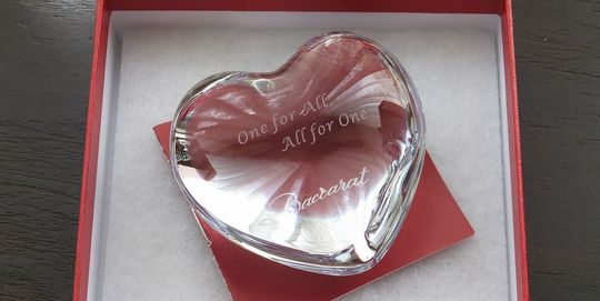 バカラのハートペーパーウエイトがレッドボックスに入っている写真。透明なクリスタル製のハートが、バカラの象徴的な赤い箱に収められ、贈り物としての高級感と特別感を際立たせています。