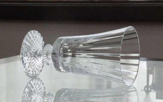 バカラのミルニュイワイングラスがテーブルの上に置いてある写真。透明なクリスタルが光を美しく反射し、その繊細なカットと独特なデザインが、食卓に優雅で神秘的な雰囲気を添えています。